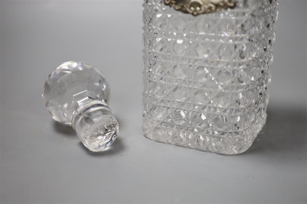 A George IV silver Whiskey label by John Riley 1824 and a cut glass decanter, height 24cm